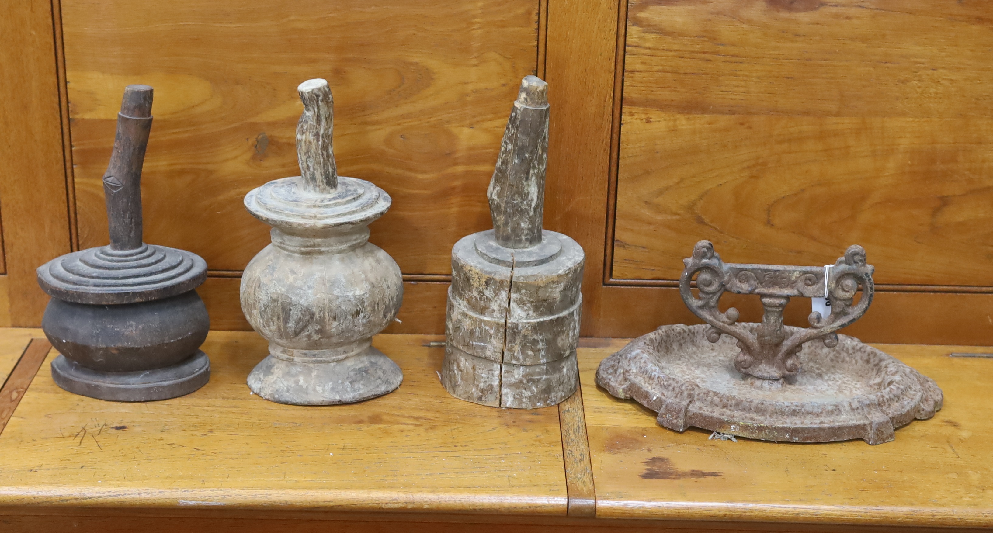 A Victorian cast iron boot scraper and three African wood mallets